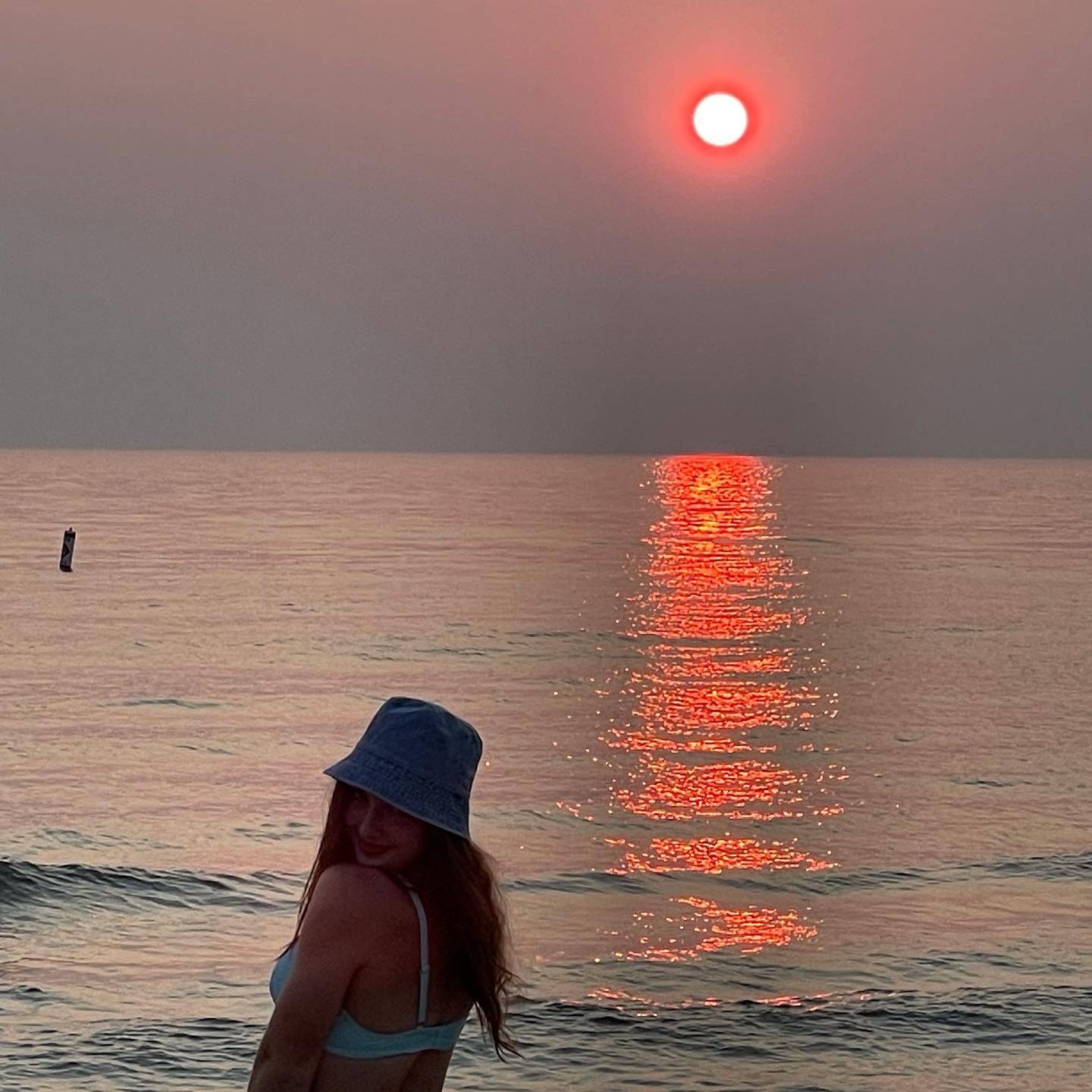 Hailey at the beach in front of the sunset